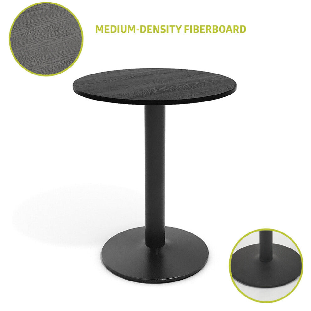 Close-up of the black wood-grain MDF tabletop and round metal foot plate of the pedestal table
