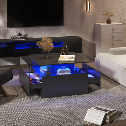 Black square LED coffee table with storage glowing blue in a TV room, side drawers open and books on the display shelf