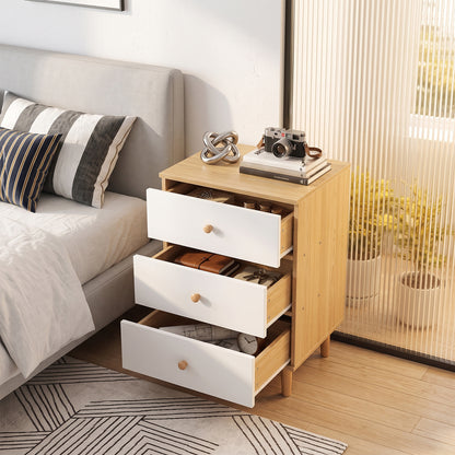 Three-drawer nightstand with drawers pulled out in a bedroom