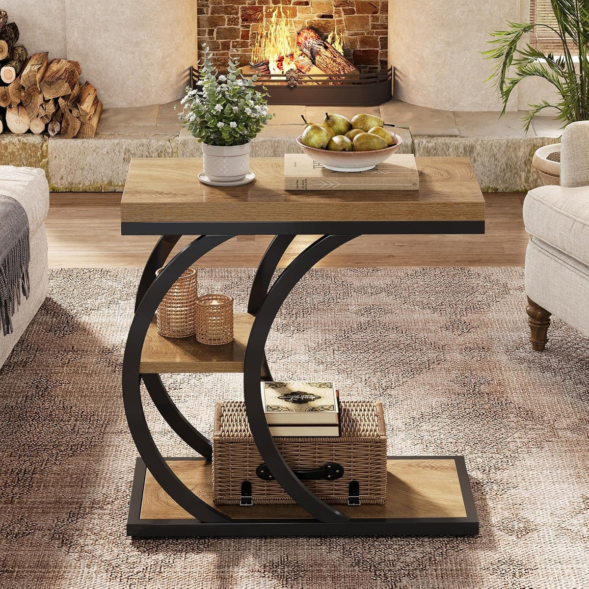 Couch side table with three tiers in a living room with a basket and books on the lower tray