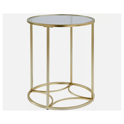 Champagne gold glass side table with round clear top and four legs on a white background