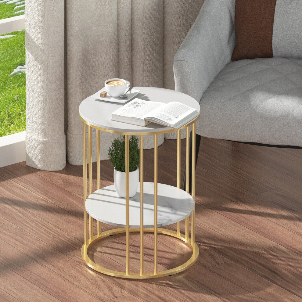 Gold round side table with white marble-effect top and lower shelf beside a grey armchair