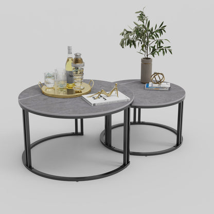Grey marble-effect round nesting coffee tables on black metal frames with gold tray and decor