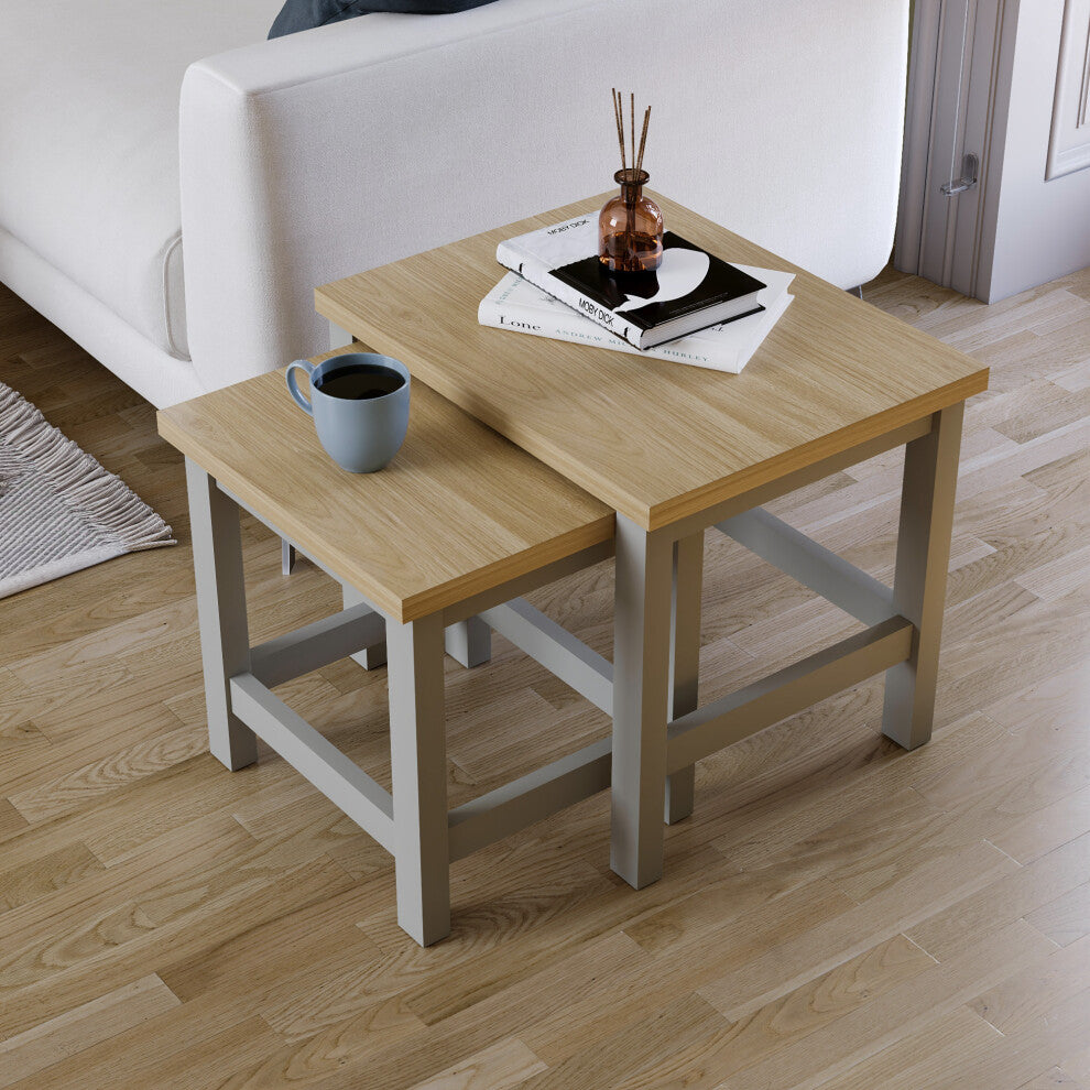 Top view of the grey and oak-effect nest of two tables partly nested on a wooden floor