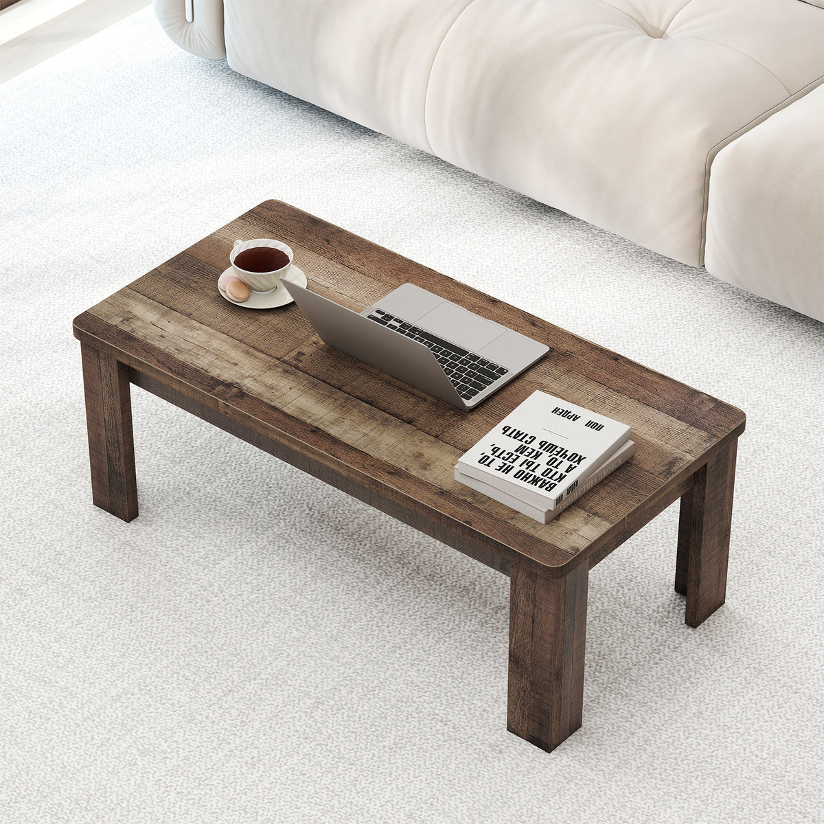 Large rectangular reclaimed-look coffee table with laptop and cup on a white rug