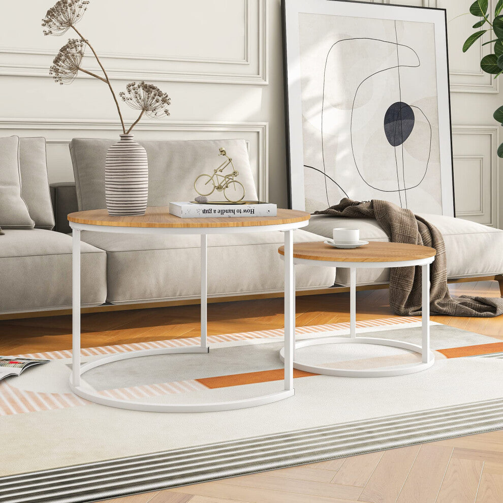Light oak and white round coffee tables side by side in front of a beige sofa