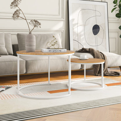Light oak and white round coffee tables side by side in front of a beige sofa