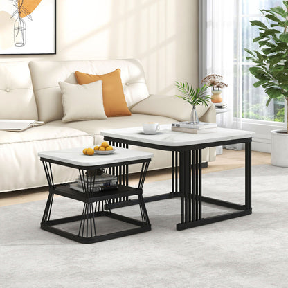 Marble effect nesting coffee tables in black and white beside a cream sofa and plant