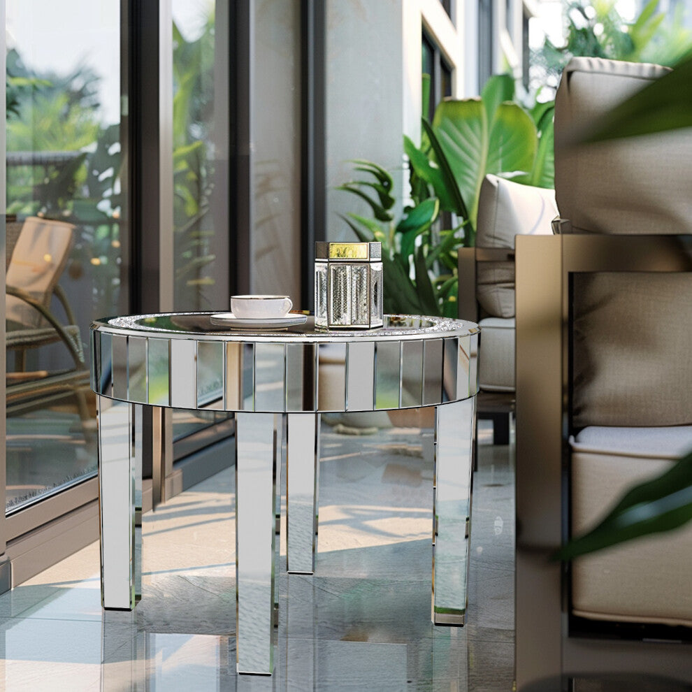 Round mirrored glass table with crystal inlay holding a teacup and lantern in a bright sunroom