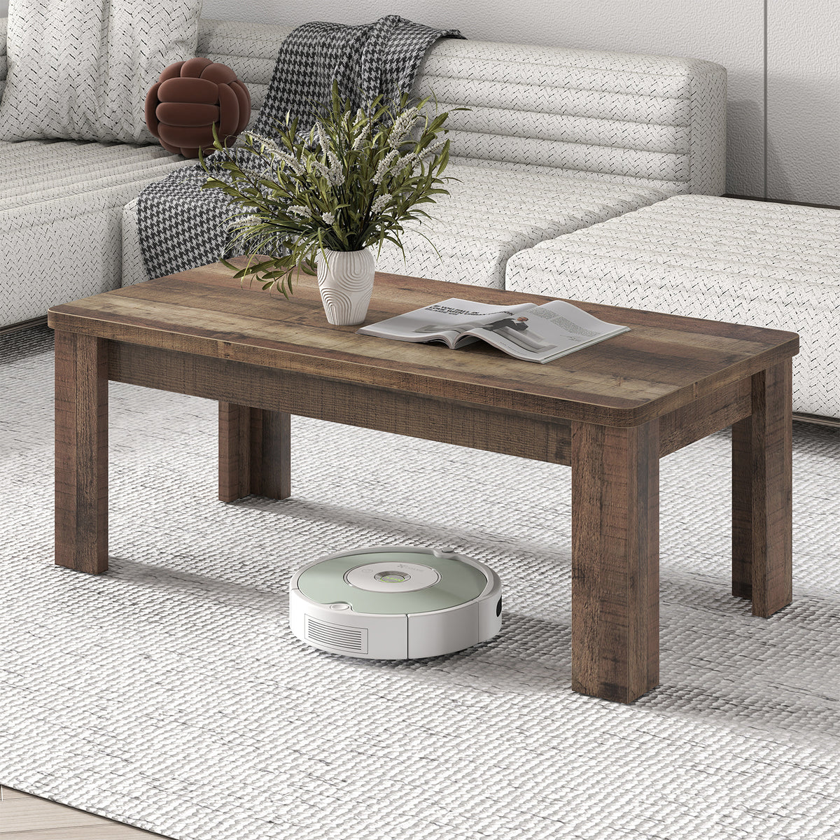 Modern rectangular coffee table in rustic wood effect styled with a plant and magazine in a grey living room