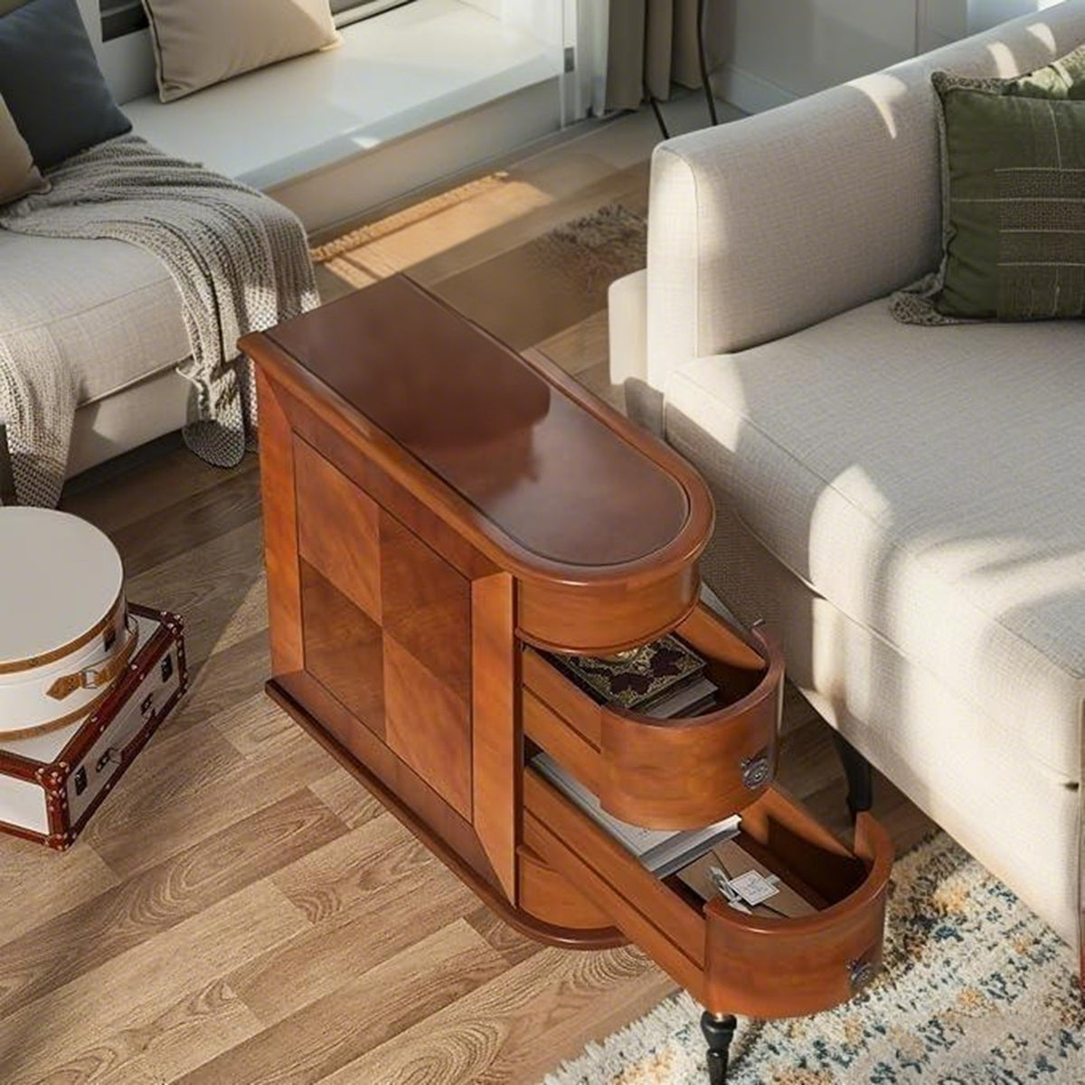Narrow end table with curved pull-out drawers open next to a sofa in a sunny living room