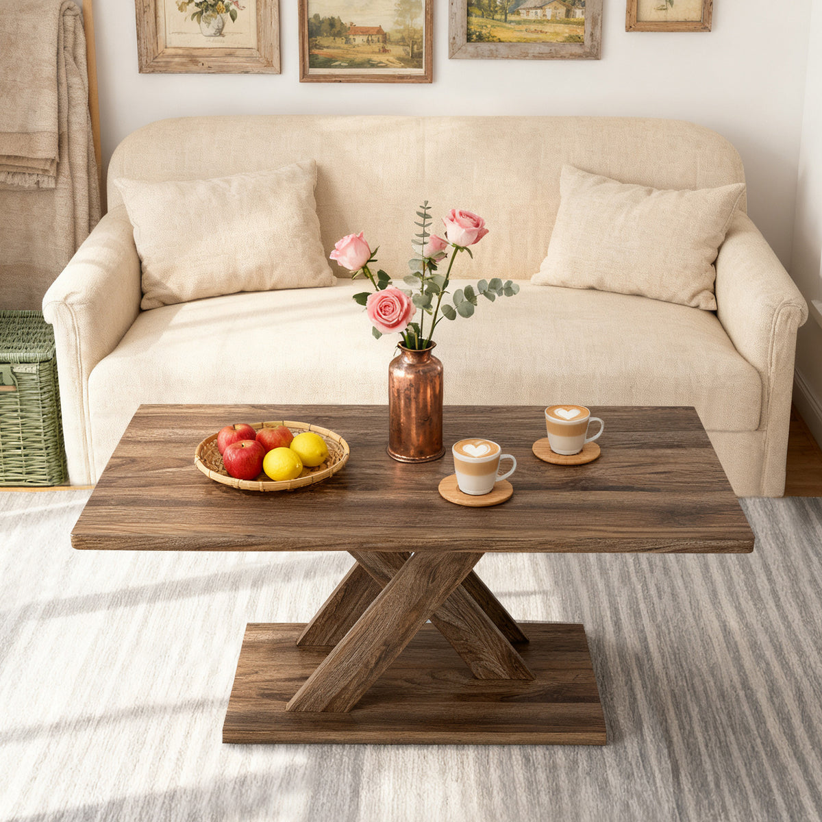Rectangular farmhouse coffee table with X-base pedestal in a cream living room with fruit bowl and flowers