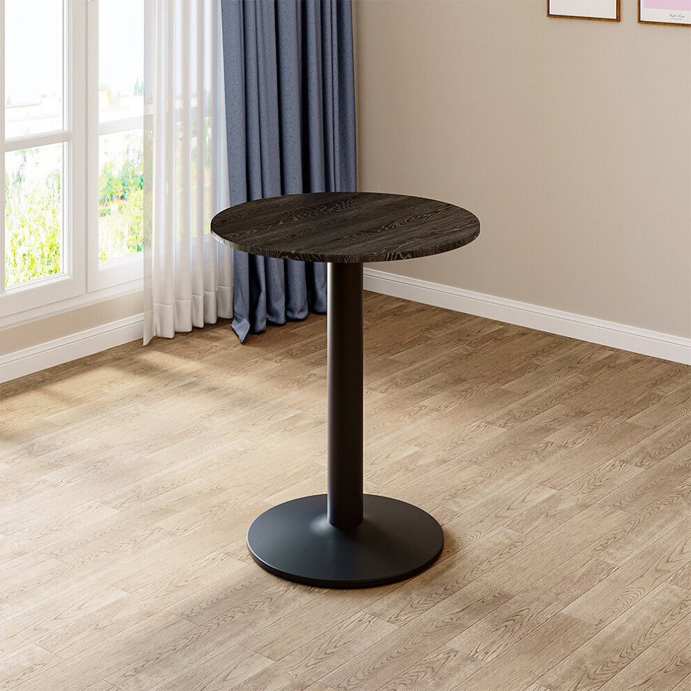 59cm round black bistro table on a single metal column standing by a window on light oak flooring