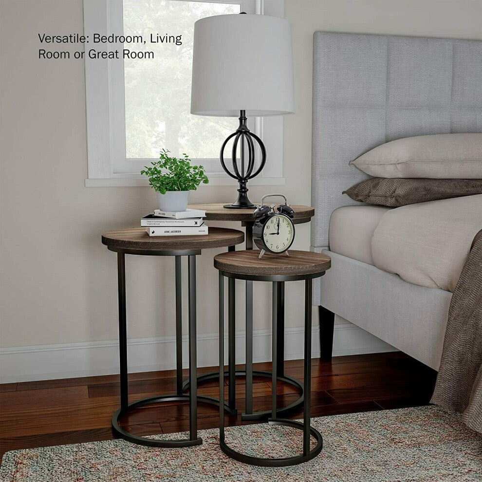 Round nest of 3 tables used as a bedside table with lamp and alarm clock