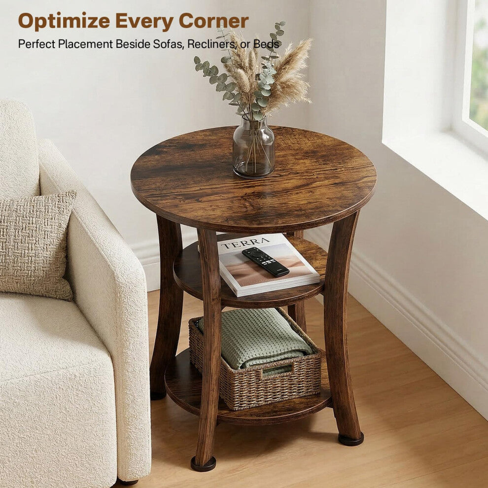 Rustic brown three tier round side table next to a cream armchair with a basket on the bottom shelf