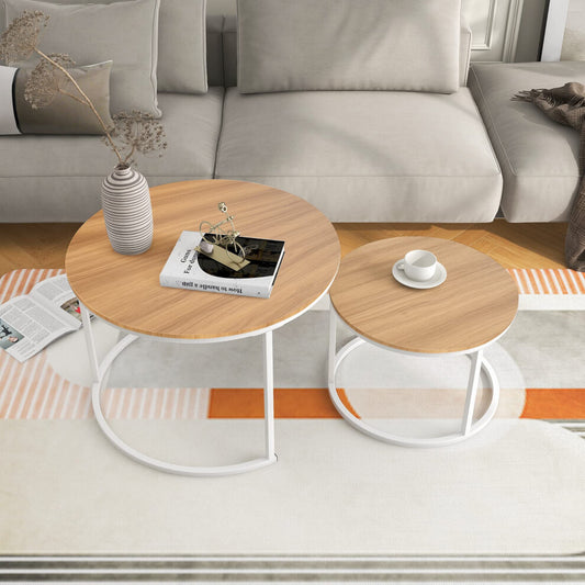 Set of 2 round wooden coffee tables with light oak-effect tops and white metal frames in a Scandi living room