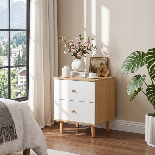 White two-drawer side table nightstand with wood legs beside a bed