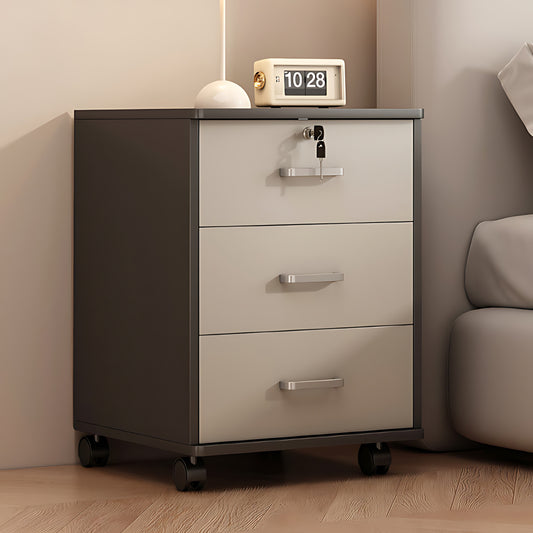 Side table with wheels and three lockable drawers beside a bed