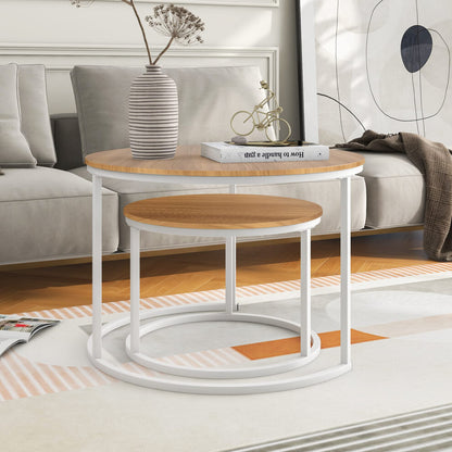Small round wooden coffee table nested fully inside the larger white-frame table