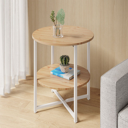 Small round wooden side table with pine-effect top and shelf beside a grey sofa