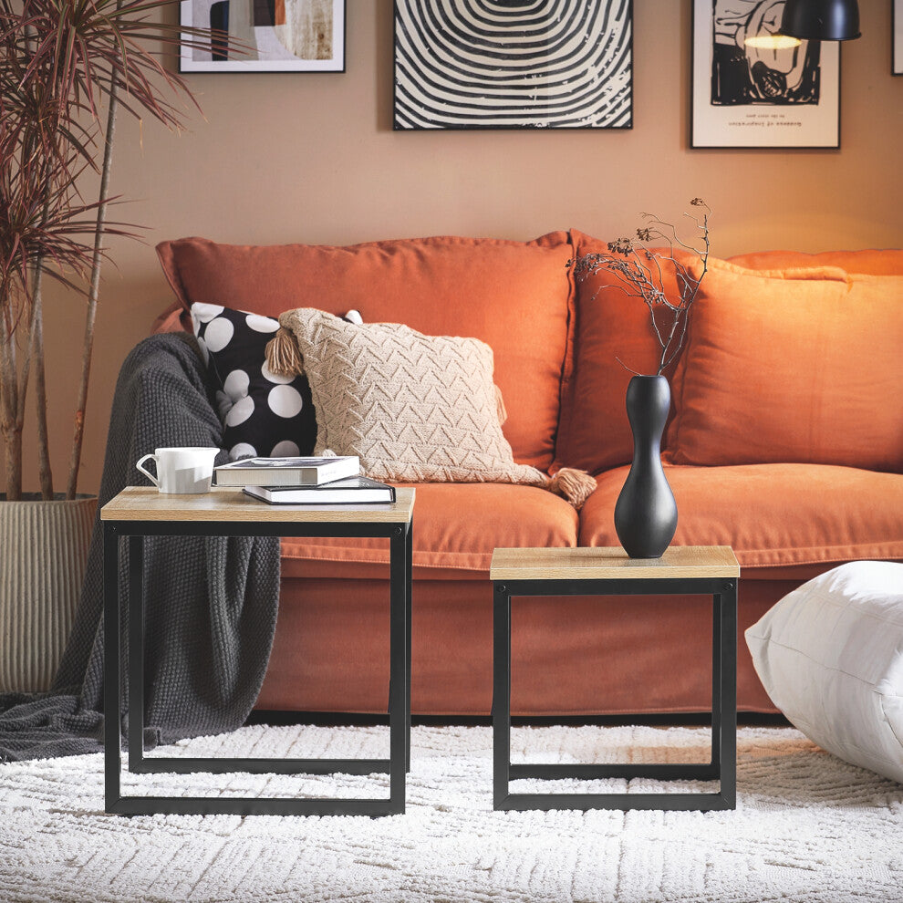 Small square coffee table set of 2 with oak-effect tops and black metal frames in front of a terracotta sofa