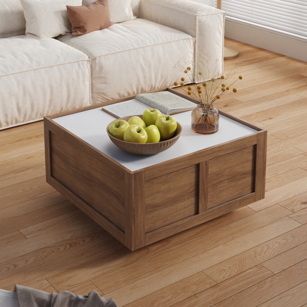 Square coffee table with storage in walnut effect with white top and bowl of green apples beside a cream sofa