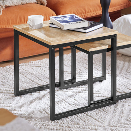 Close-up of the oak-effect tops and black metal U-frames of the square nest of tables on a white rug