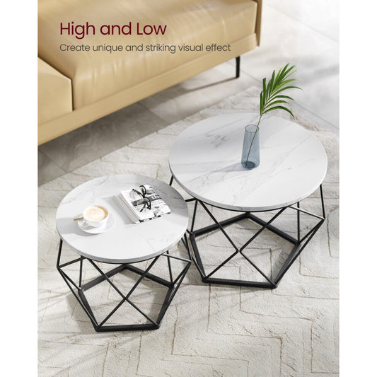 Two white marble-effect round coffee tables with geometric black frames on a cream rug