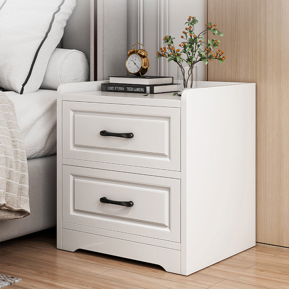 White bedside cabinet with two drawers in a bright bedroom