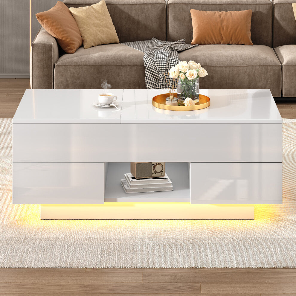 White high gloss coffee table with drawers, open cubby and warm LED plinth in front of a taupe sofa