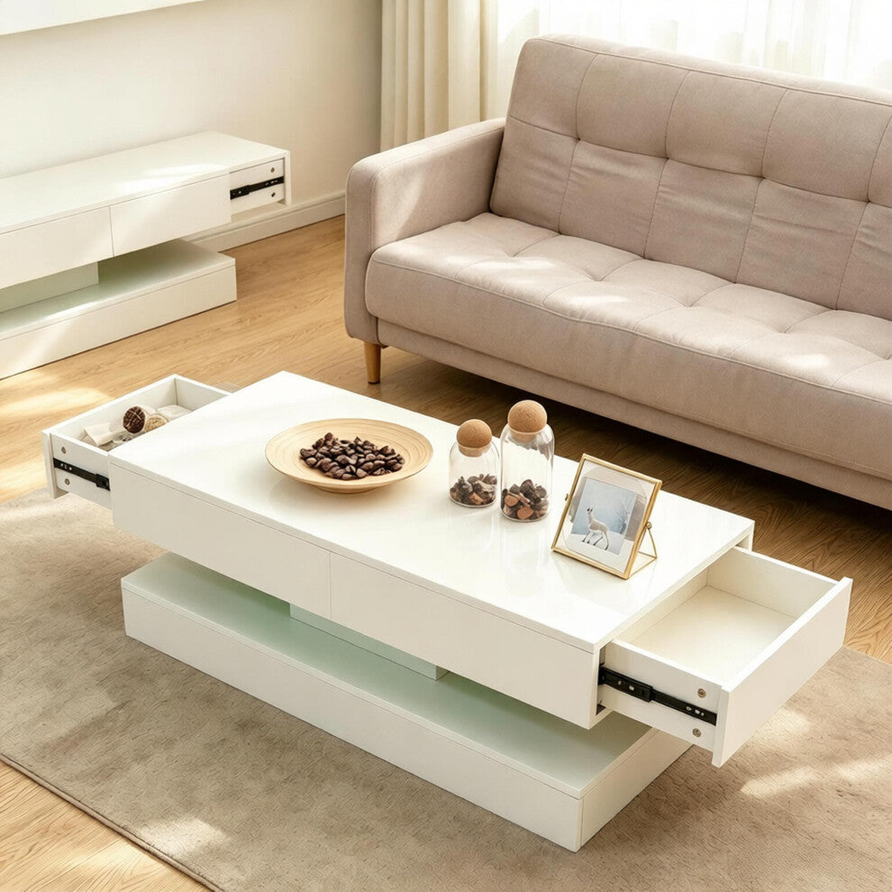 White gloss coffee table with hidden end drawers in a bright living room beside a beige sofa