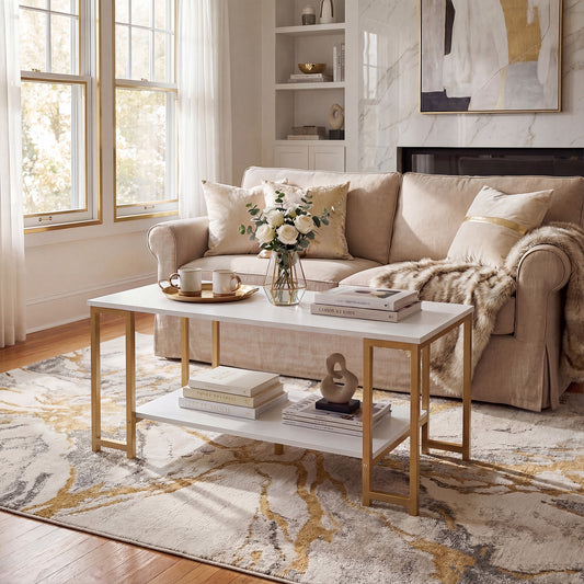 White and gold rectangular coffee table with open shelf in a bright living room with marble-look wall