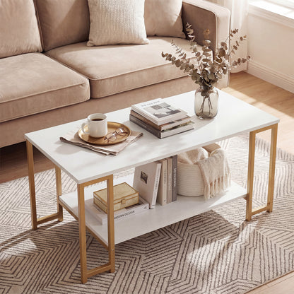 White two-tier coffee table with gold-tone metal legs styled with tea tray, books and vase